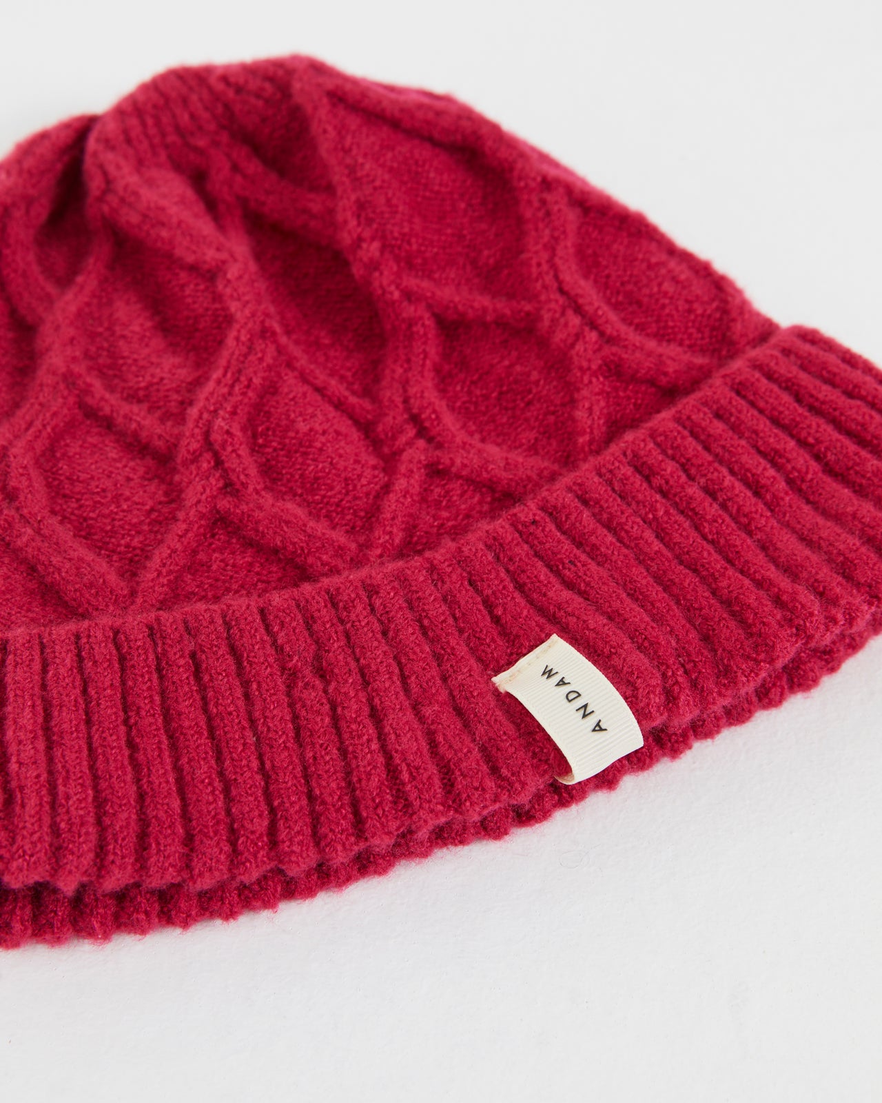 Women's knitted hat with braided structure