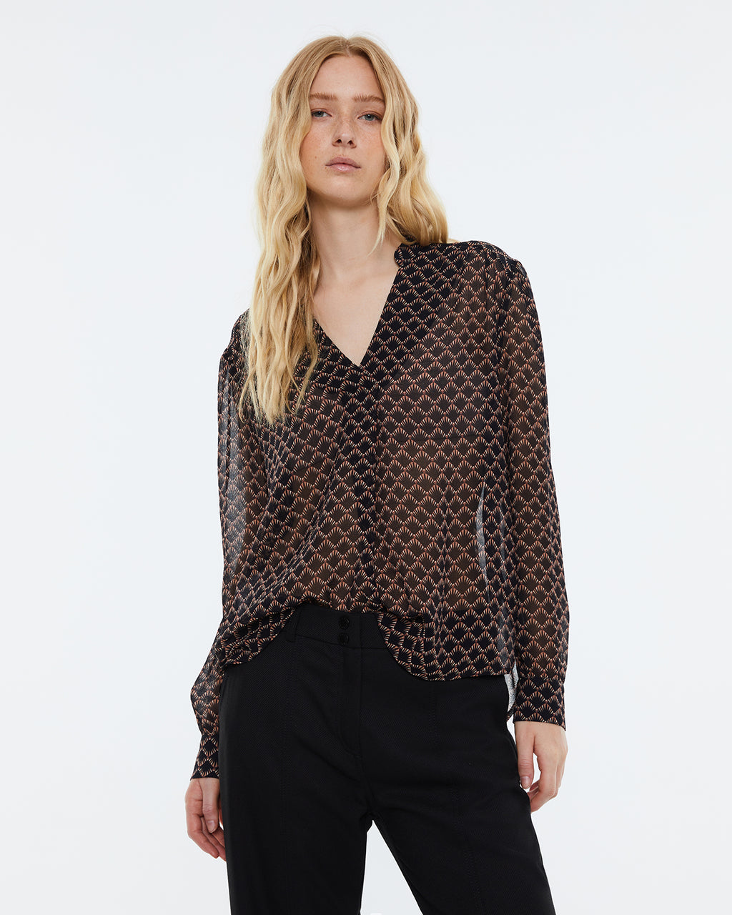 Women's printed blouse with a V-neck and long sleeves.