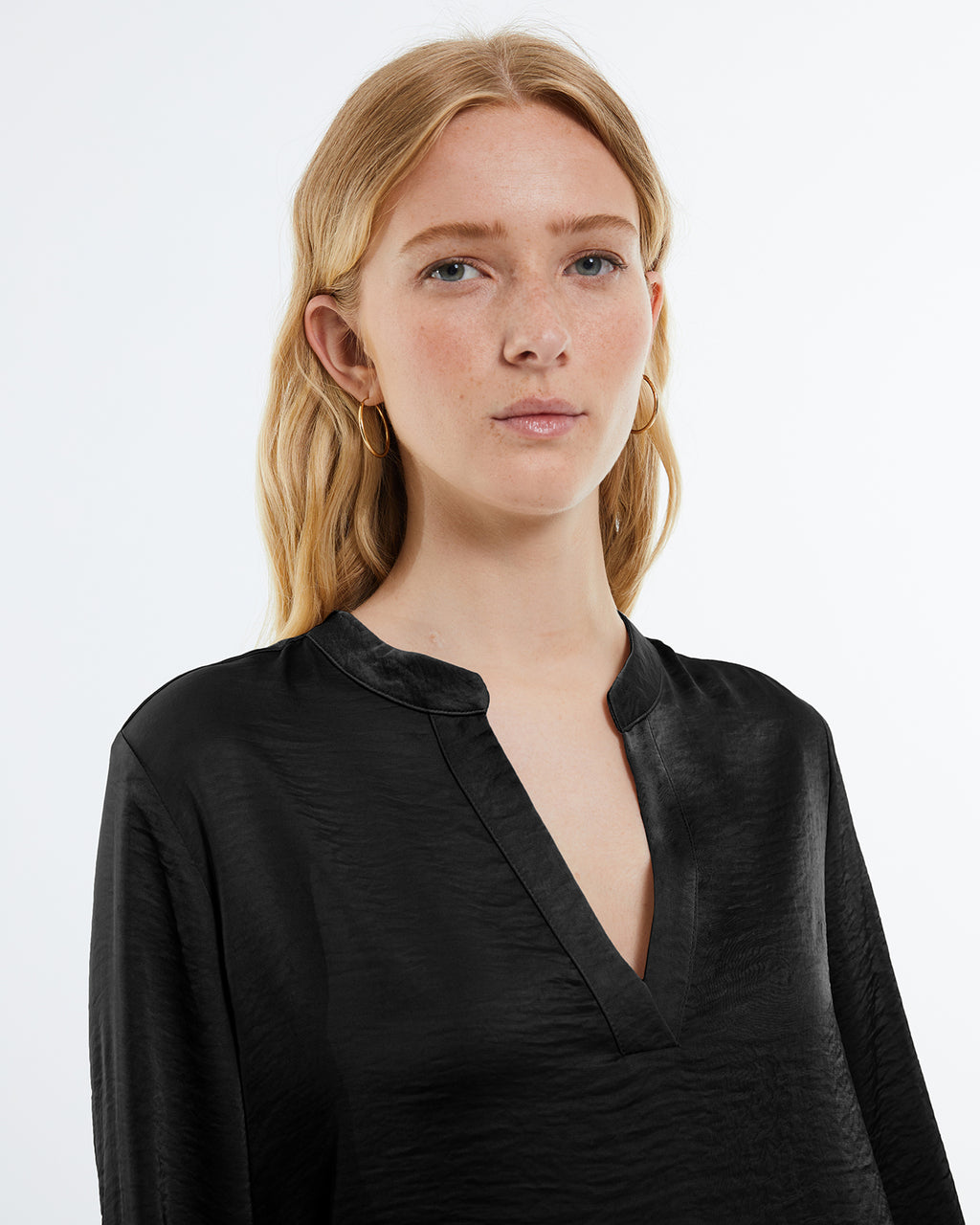 Women's satin blouse with long sleeves, mandarin collar and V-neckline.