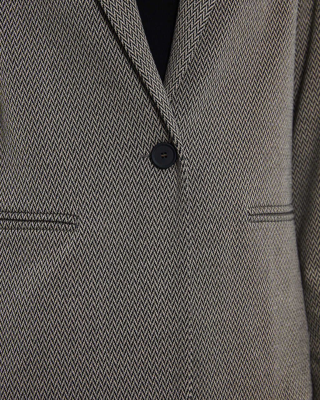 Women's blazer in herringbone knit fabric.