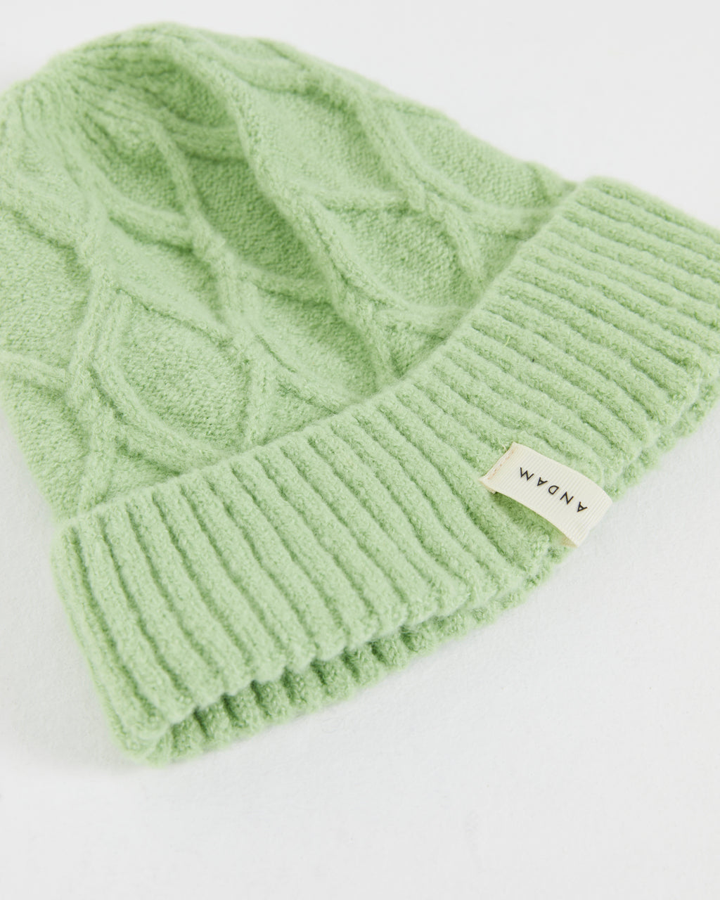 Women's knitted hat with braided structure