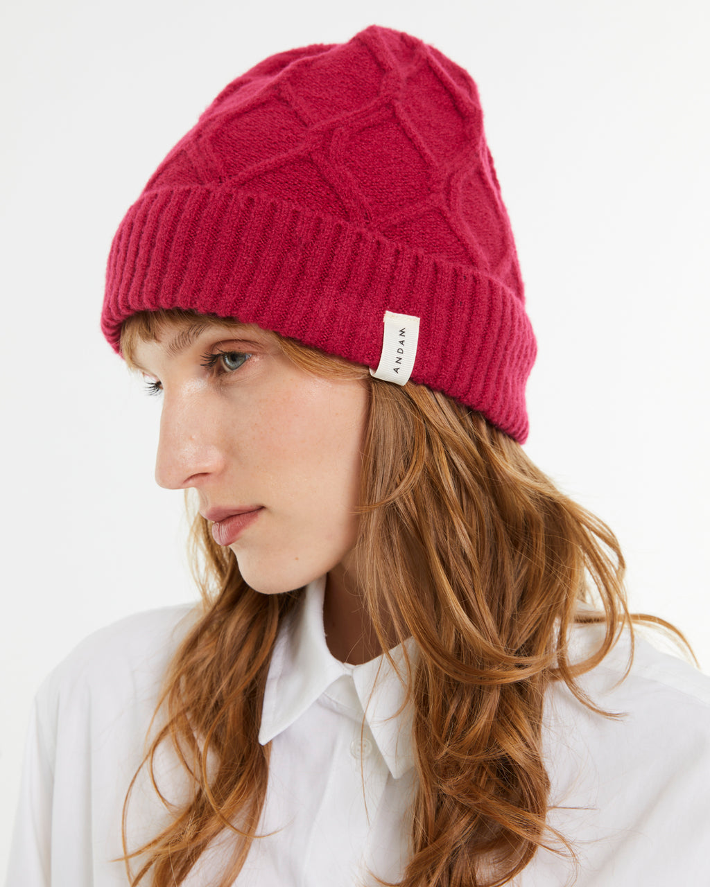 Women's knitted hat with braided structure