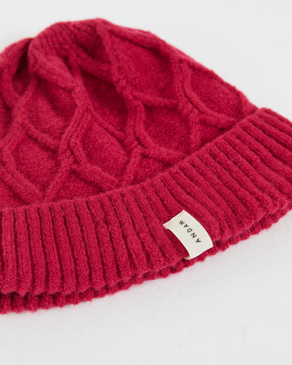 Women's knitted hat with braided structure